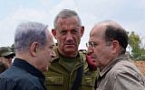 Prime Minister Benjamin Netanyahu, left, meets with then-IDF chief of staff Benny Gantz, center, and then-defense minister Moshe Ya'alon, right, in southern Israel on July 21, 2014. (Kobi Gideon/GPO/Flash90)