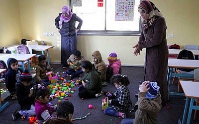 Illustrative photo of deaf Palestinian children playing at a rehabilitation foundation for deaf children, in Khan Younis in the Gaza Strip. January 18, 2015. (Abed Rahim Khatib/Flash90)