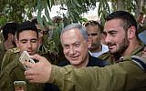 Benjamin Netanyahu taking a selfie with troops near the Gaza Border on May 3, 2016. (Amos Ben Gershom/GPO)