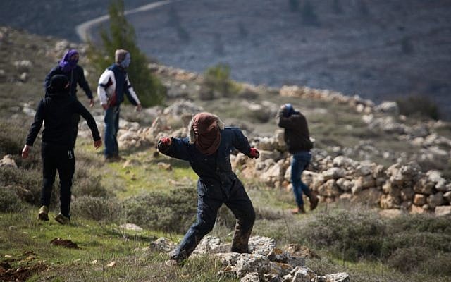 Young Jewish protesters throw rocks at police forces at the illegal outpost of Amona, on February 1, 2017, on the morning of the settlement's evacuation. (Hadas Parush/Flash90) Young Jewish protesters throw rocks at police forces at the illegal outpost of Amona, on February 1, 2017, on the morning of the settlement's evacuation. (Hadas Parush/Flash90)