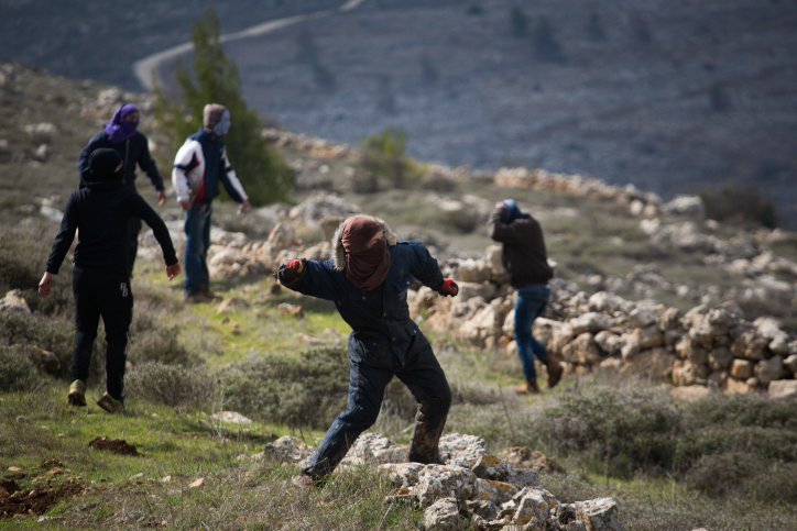 Young Jewish protesters throw rocks at police forces at the illegal outpost of Amona, on February 1, 2017, on the morning of the settlement's evacuation. (Hadas Parush/Flash90) Young Jewish protesters throw rocks at police forces at the illegal outpost of Amona, on February 1, 2017, on the morning of the settlement's evacuation. (Hadas Parush/Flash90)