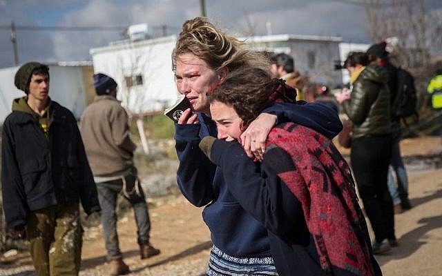 Israeli girls react during the evacuation of the illegal outpost of Amona, on February 1, 2017. (Hadas Parush/Flash90)