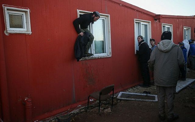 Protesters surround the Amona synagogue on the morning of the second day into the evacuation of the illegal outpost on February 2, 2017. (Yonatan Sindel/Flash90) 