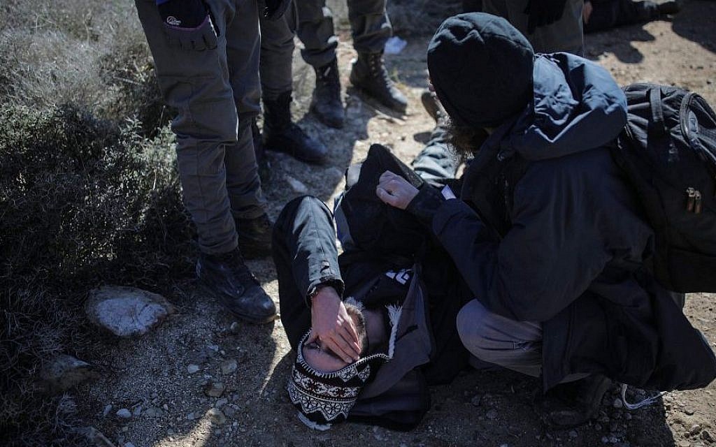 Israeli police forces evacuate people from the synagogue of the illegal outpost of Amona, on the second day into the eviction on February 2, 2017. (Yonatan Sindel/Flash90) Israeli police forces evacuate people from the synagogue of the illegal outpost of Amona, on the second day into the eviction on February 2, 2017. (Yonatan Sindel/Flash90)