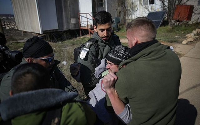 Illustrative. Israeli police forcibly evacuate a young man from the synagogue of the illegal outpost of Amona on February 2, 2017. (Yonatan Sindel/Flash90) Illustrative. Israeli police forcibly evacuate a young man from the synagogue of the illegal outpost of Amona on February 2, 2017. (Yonatan Sindel/Flash90)