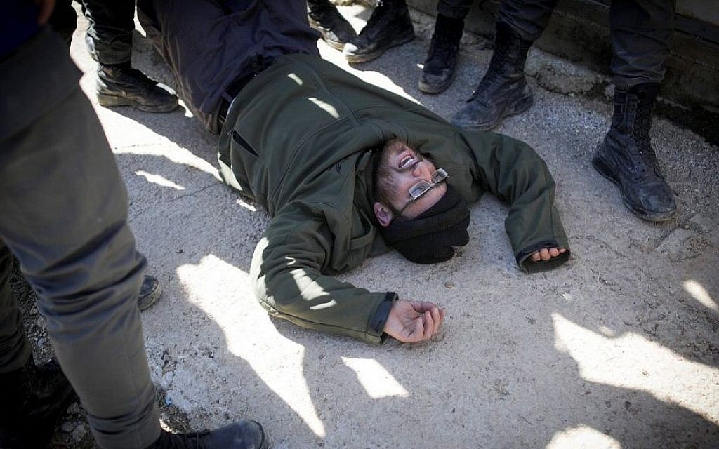 Israeli police forces evacuate people from the synagogue of the illegal outpost of Amona, on the second day into the eviction on February 2, 2017. (Yonatan Sindel/Flash90) Israeli police forces evacuate people from the synagogue of the illegal outpost of Amona, on the second day into the eviction on February 2, 2017. (Yonatan Sindel/Flash90)