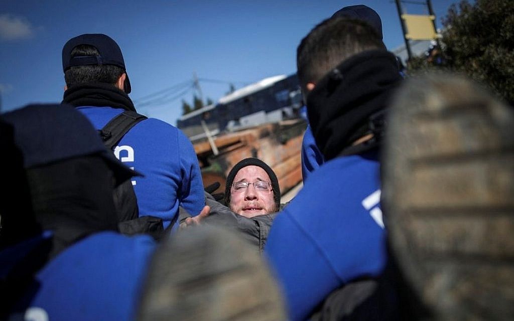 Israeli police forces evacuate people from the synagogue of the illegal outpost of Amona, on the second day into the eviction on February 2, 2017. (Yonatan Sindel/Flash90) Israeli police forces evacuate people from the synagogue of the illegal outpost of Amona, on the second day into the eviction on February 2, 2017. (Yonatan Sindel/Flash90)