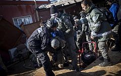 Israeli police forces evacuate people from the synagogue the illegal outpost of Amona, on the second day into the eviction on February 2, 2017.(Yonatan Sindel/Flash90)