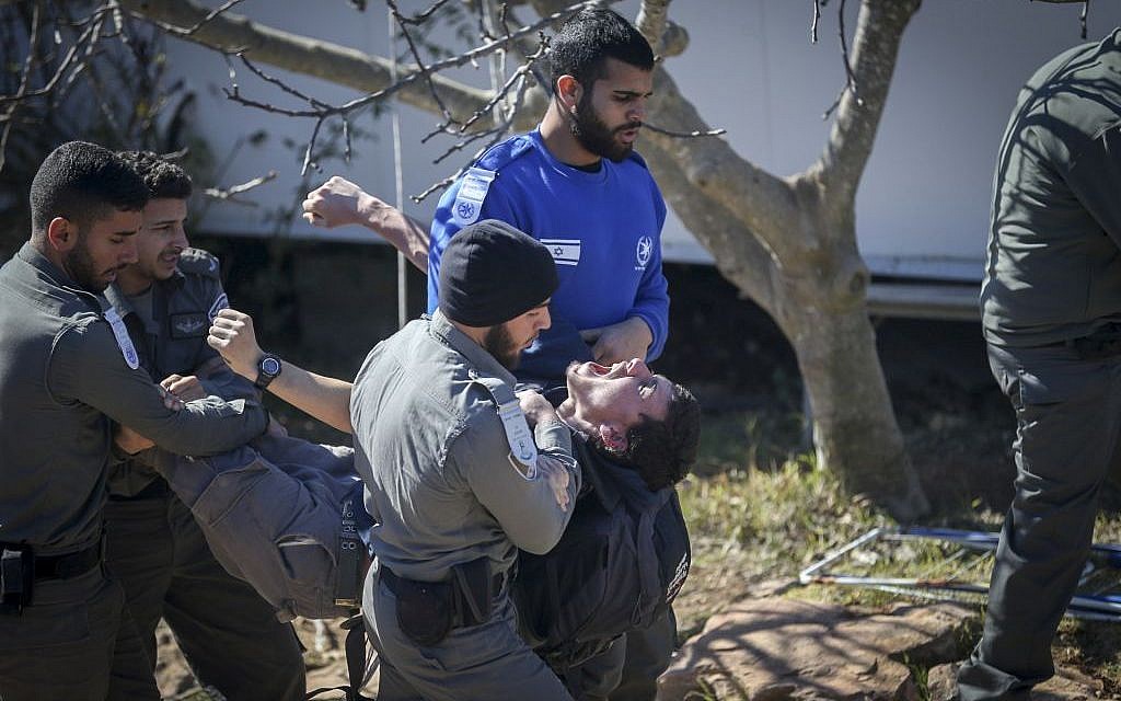 Police officers remove protesters as they evacuate the synagogue at the West Bank outpost of Amona on February 2, 2017 (Photo by Yonatan Sindel/Flash90) Police officers remove protesters as they evacuate the synagogue at the West Bank outpost of Amona on February 2, 2017 (Photo by Yonatan Sindel/Flash90)