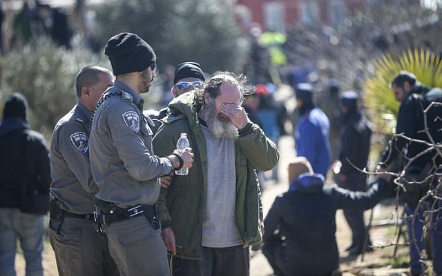 An Israeli settler reacts during evacuation of the illegal outpost of Amona, on the second day into the eviction on February 2, 2017. (Yonatan Sindel/Flash90) An Israeli settler reacts during evacuation of the illegal outpost of Amona, on the second day into the eviction on February 2, 2017. (Yonatan Sindel/Flash90)