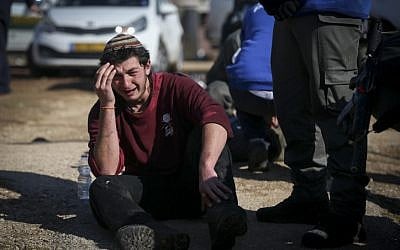 A protester weeps as police forces evacuate people from the synagogue at Amona, on the second day of the eviction of the illegal West Bank outpost on February 2, 2017. (Yonatan Sindel/Flash90) A protester weeps as police forces evacuate people from the synagogue at Amona, on the second day of the eviction of the illegal West Bank outpost on February 2, 2017. (Yonatan Sindel/Flash90)