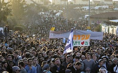 Protesters attend a demonstration against the demolition of nine homes in the Ofra settlement of the West Bank on February 5, 2017. (Noam Revkin Fenton/Flash90)