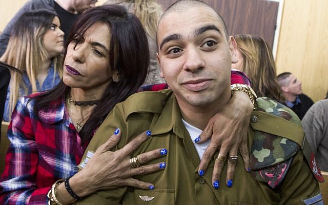IDF Sgt. Elor Azaria, who shot dead a disarmed and injured Palestinian attacker in the West Bank city of Hebron in March 2016, is surrounded by family and friends as he awaits to hear his sentence in a courtroom at the Kirya military base in Tel Aviv, on February 21, 2017 (Jim Hollander/POOL) IDF Sgt. Elor Azaria, who shot dead a disarmed and injured Palestinian attacker in the West Bank city of Hebron in March 2016, is surrounded by family and friends as he awaits to hear his sentence in a courtroom at the Kirya military base in Tel Aviv, on February 21, 2017 (Jim Hollander/POOL)