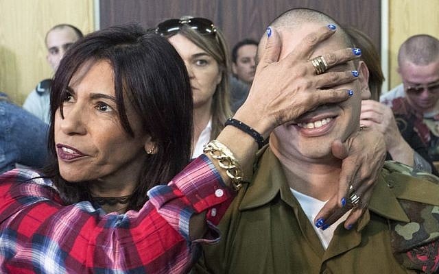 IDF Sgt. Elor Azaria, who shot dead a disarmed and injured Palestinian attacker in the West Bank city of Hebron in March 2016, is surrounded by family and friends as he awaits to hear his sentence in a courtroom at the Kirya military base in Tel Aviv, on February 21, 2017 (Jim Hollander/POOL) IDF Sgt. Elor Azaria, who shot dead a disarmed and injured Palestinian attacker in the West Bank city of Hebron in March 2016, is surrounded by family and friends as he awaits to hear his sentence in a courtroom at the Kirya military base in Tel Aviv, on February 21, 2017 (Jim Hollander/POOL)