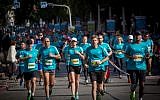Illustrative: Runners take part in a marathon in Israel's coastal city of Tel Aviv on February 24, 2017. (Miriam Alster/Flash90)