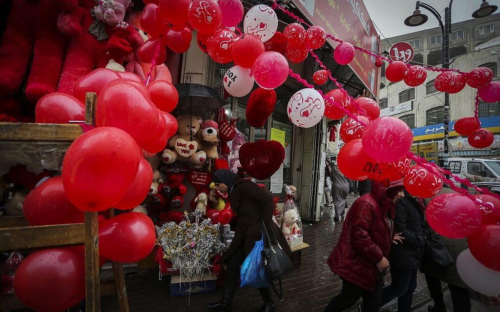 A Palestinian vendor sells gifts for Valentine's Day at a shop in the West Bank city of Ramallah on February 14, 2016. (Photo by Flash90) A Palestinian vendor sells gifts for Valentine's Day at a shop in the West Bank city of Ramallah on February 14, 2016. (Photo by Flash90)