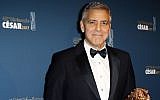 Actor George Clooney poses with the Honorary Cesar award during a photocall at the 42nd Cesar Film Awards ceremony at Salle Pleyel in Paris, Friday, Feb. 24, 2017. This annual ceremony is presented by the French Academy of Cinema Arts and Techniques. (AP/Francois Mori)