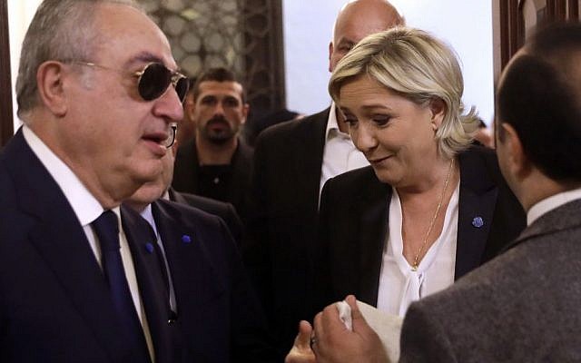 An aide of Lebanon's Grand Mufti Sheikh Abdel-Latif Derian, right, holds a head scarf as he tries to convince French far-right presidential candidate Marine Le Pen, centre, to wear it during her meeting with the Mufti at Dar al-Fatwa, the headquarters of the Sunni Mufti, in Beirut, Feb.21, 2017. (AP/Hussein Malla) An aide of Lebanon's Grand Mufti Sheikh Abdel-Latif Derian, right, holds a head scarf as he tries to convince French far-right presidential candidate Marine Le Pen, centre, to wear it during her meeting with the Mufti at Dar al-Fatwa, the headquarters of the Sunni Mufti, in Beirut, Feb.21, 2017. (AP/Hussein Malla)