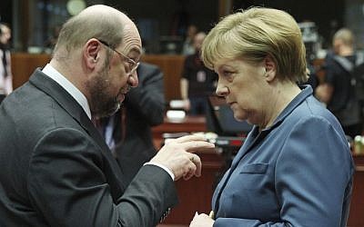 In this Dec. 19, 2013 photo then European Parliament President Martin Schulz, left, talks with German Chancellor Angela Merkel, during an EU summit at the European Council building in Brussels. (AP/Yves Logghe)