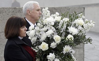 US Vice President Mike Pence and his wife Karen, left, lay a wreath during a visit to the former Nazi concentration camp in Dachau near Munich, southern Germany, Sunday, Feb. 19, 2017. (AP Photo/Matthias Schrader)
