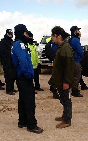 A protester shouts at a police officer during the evacuation of the illegal Amona outpost in the West Bank on February 1, 2017. (Judah Ari Gross/Times of Israel)