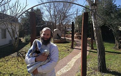 Former resident of the Amona outpost Avraham Rossana holding his 3-month-old baby in the Ofra Seminary campus, February 2, 2017. (Raoul Wootliff/Times of Israel) Former resident of the Amona outpost Avraham Rossana holding his 3-month-old baby in the Ofra Seminary campus, February 2, 2017. (Raoul Wootliff/Times of Israel)