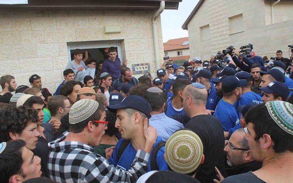 Protesters and police confront each other outside a home slated for demolition in the West Bank Settlement of Ofra on Tuesday February 28, 2017 (Raoul Wootliff/Times of Israel)