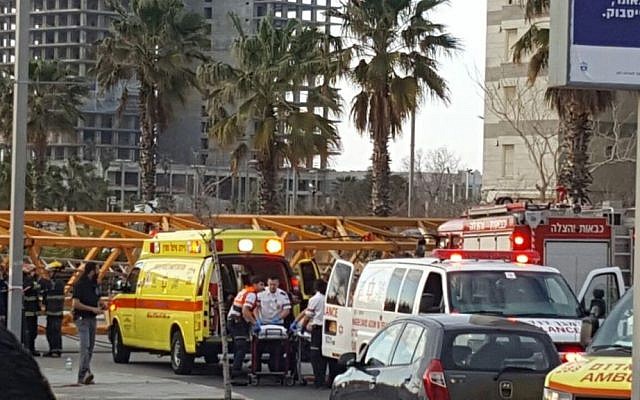 EMTs treat the injured after a crane collapsed at a construction site in the central Israel city of Bat Yam on February 13, 2017. (Magen David Adom spokeswoman) EMTs treat the injured after a crane collapsed at a construction site in the central Israel city of Bat Yam on February 13, 2017. (Magen David Adom spokeswoman)
