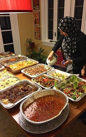 Khlood Alnablise puts the finishing touches on her spread at Syria Supper Club dinner in Maplewood, NJ, October 2016. (Courtesy)