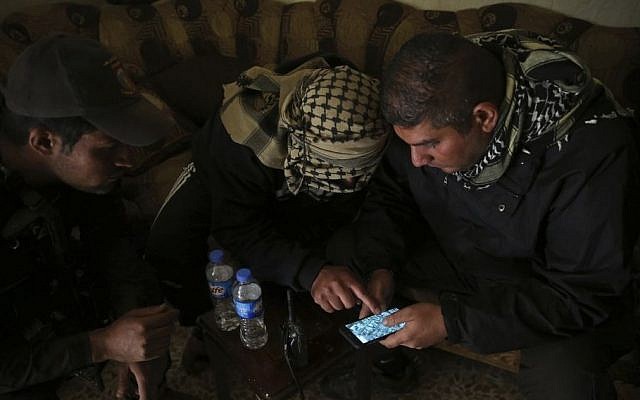 In this Nov. 25, 2016 photo, special forces Lt. Col. Ali Hussein, right, listens to an Iraqi informant, center, giving information about Islamic State militant positions on a mobile map, in the Bakr front line neighborhood, in Mosul, Iraq. (AP Photo/Hussein Malla) In this Nov. 25, 2016 photo, special forces Lt. Col. Ali Hussein, right, listens to an Iraqi informant, center, giving information about Islamic State militant positions on a mobile map, in the Bakr front line neighborhood, in Mosul, Iraq. (AP Photo/Hussein Malla)