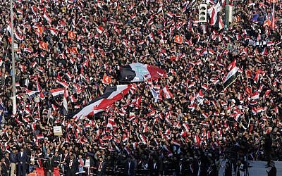 Followers of Iraq's influential Shiite cleric Muqtada al-Sadr chant slogans as they wave national flags during a demonstration against corruption in Baghdad, Iraq, Saturday, Feb. 11, 2017 (AP/Karim Kadim)