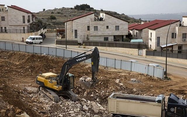 Workmen operate heavy machinery at a construction site in the West Bank settlement of Ariel on Jan. 25, 2017. (AP/Ariel Schalit, File) Workmen operate heavy machinery at a construction site in the West Bank settlement of Ariel on Jan. 25, 2017. (AP/Ariel Schalit, File)