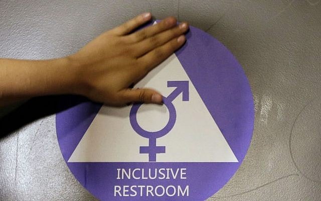 In this May 17, 2016 file photo, a new sticker is placed on the door at the ceremonial opening of a gender neutral bathroom at Nathan Hale High School in Seattle. (AP Photo/Elaine Thompson, File) In this May 17, 2016 file photo, a new sticker is placed on the door at the ceremonial opening of a gender neutral bathroom at Nathan Hale High School in Seattle. (AP Photo/Elaine Thompson, File)