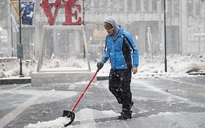 A man clears snow from Dilworth Park during a winter storm in Philadelphia, Thursday, Februay 9, 2017. (AP Photo/Matt Rourke)