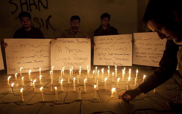 Pakistani students light candles to condemn the recent attack on a shrine in interior Sind province, Thursday, Feb. 16, 2017 in Karachi, Pakistan. (AP Photo/Shakil Adil)