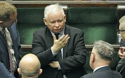 In this Jan. 25, 2017 file photo, Jaroslaw Kaczynski, center, the leader of the ruling Law and Justice party, speaks with lawmakers in parliament in Warsaw, Poland. (AP Photo/Alik Keplicz)