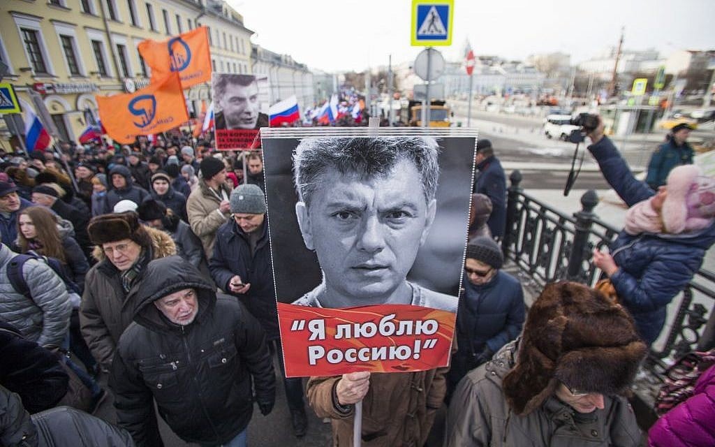People march in memory of opposition leader Boris Nemtsov, portrait in center, in Moscow, Russia, Sunday, February 26, 2017. (AP/Ivan Sekretarev)