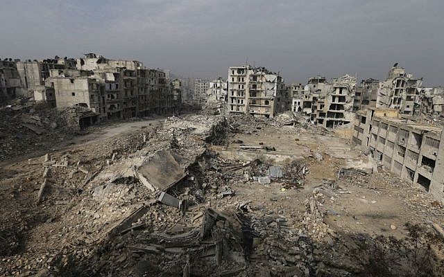 In this Friday, January 20, 2017 photo, mounds of rubble remain from what used to be high rise apartment buildings in the once rebel-held Ansari neighborhood of eastern Aleppo, Syria. Aleppo. (AP Photo/Hassan Ammar)