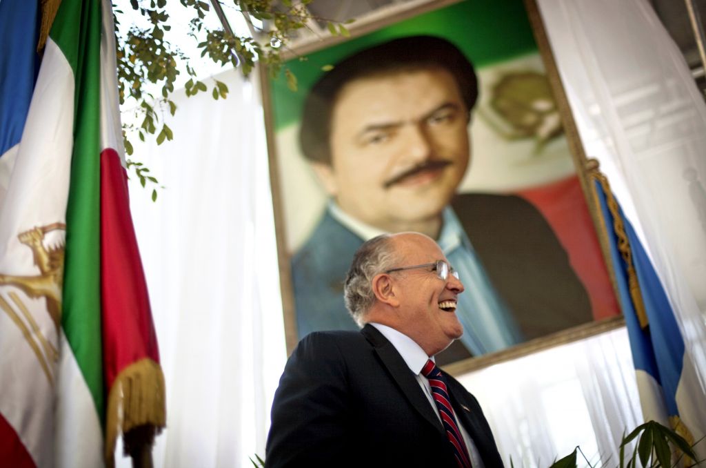Former New York City Mayor Rudy Giuliani walks under a photo of Iran opposition leader Massoud Rajavi as he takes the podium to speak at a protest of Iranian President Mahmoud Ahmadinejad's visit to the United Nations, in New York, Thursday, Sept. 23, 2010. (AP Photo/David Goldman) Former New York City Mayor Rudy Giuliani walks under a photo of Iran opposition leader Massoud Rajavi as he takes the podium to speak at a protest of Iranian President Mahmoud Ahmadinejad's visit to the United Nations, in New York, Thursday, Sept. 23, 2010. (AP Photo/David Goldman)