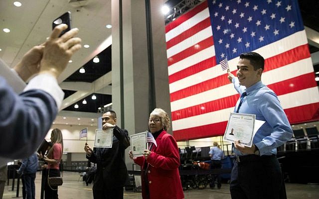In this Wednesday, Feb. 15, 2017, file photo, Erik Danialian, a 21-year-old immigrant from Iran, poses with his US citizenship certificate in front of a large US flag after a naturalization ceremony at the Los Angeles Convention Center, in Los Angeles, California. (AP Photo/Jae C. Hong, File) In this Wednesday, Feb. 15, 2017, file photo, Erik Danialian, a 21-year-old immigrant from Iran, poses with his US citizenship certificate in front of a large US flag after a naturalization ceremony at the Los Angeles Convention Center, in Los Angeles, California. (AP Photo/Jae C. Hong, File)