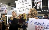 Protesters against US President Donald Trump's temporary travel ban on citizens from seven Muslim-majority nations stand in front of the Bradley Terminal at Los Angeles International Airport, Saturday, Feb. 4, 2017, in Los Angeles. (AP Photo/Reed Saxon)