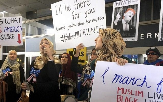 Protesters against US President Donald Trump's temporary travel ban on citizens from seven Muslim-majority nations stand in front of the Bradley Terminal at Los Angeles International Airport, Saturday, Feb. 4, 2017, in Los Angeles. (AP Photo/Reed Saxon) Protesters against US President Donald Trump's temporary travel ban on citizens from seven Muslim-majority nations stand in front of the Bradley Terminal at Los Angeles International Airport, Saturday, Feb. 4, 2017, in Los Angeles. (AP Photo/Reed Saxon)