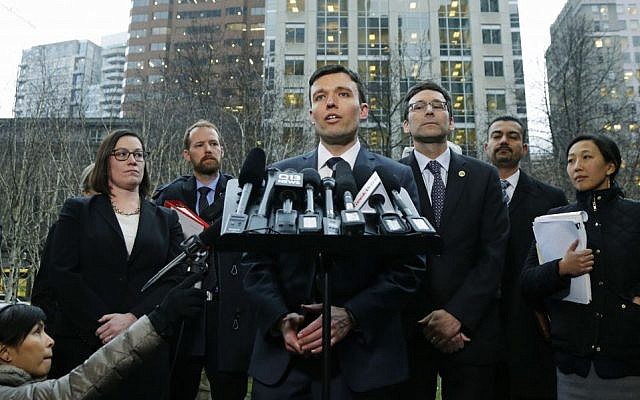 Washington state Solicitor General Noah Purcell, center, talks to reporters as Attorney General Bob Ferguson, third from right, looks on, Friday, Feb. 3, 2017, following a hearing in federal court in Seattle.(AP Photo/Ted S. Warren) Washington state Solicitor General Noah Purcell, center, talks to reporters as Attorney General Bob Ferguson, third from right, looks on, Friday, Feb. 3, 2017, following a hearing in federal court in Seattle.(AP Photo/Ted S. Warren)