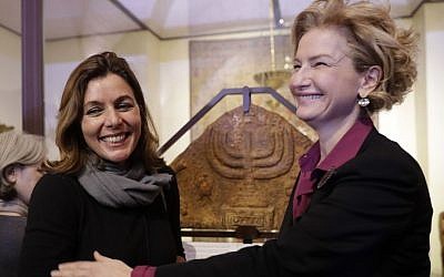 Director of the Vatican Museums, Barbara Jatta, left, and Director of Rome's Jewish Museum Alessandra Di Castro pose for a photo in front of a bas-relief showing a menorah at the end of a press conference in Rome, Monday, February 20, 2017. (AP/Alessandra Tarantino)