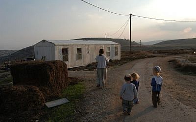 A family walking in the Adei Ad outpost on November 27, 2003. (Flash90 )