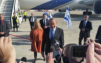 Benjamin Netanyahu, with his wife Sara Netanyahu behind him, speaking to the press before boarding a plane to the US, at Ben-Gurion Airport, on February 13, 2017. (Raphael Ahren/Times of Israel) Benjamin Netanyahu, with his wife Sara Netanyahu behind him, speaking to the press before boarding a plane to the US, at Ben-Gurion Airport, on February 13, 2017. (Raphael Ahren/Times of Israel)