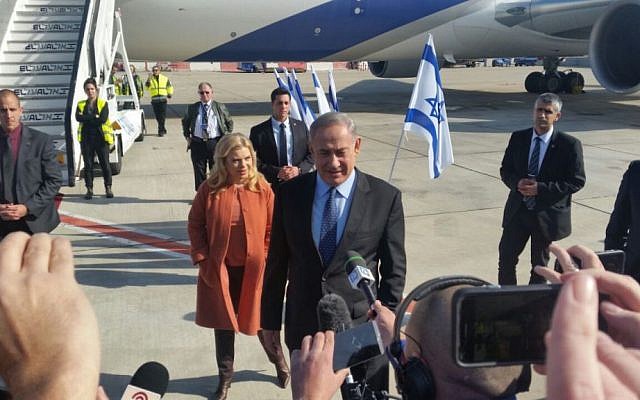 Benjamin Netanyahu, with his wife Sara Netanyahu behind him, speaking to the press before boarding a plane to the US, at Ben-Gurion Airport, on February 13, 2017. (Raphael Ahren/Times of Israel) Benjamin Netanyahu, with his wife Sara Netanyahu behind him, speaking to the press before boarding a plane to the US, at Ben-Gurion Airport, on February 13, 2017. (Raphael Ahren/Times of Israel)