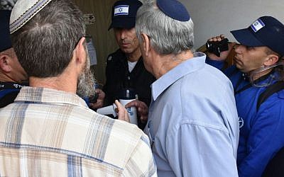Police officers speak to protesters and residents of nine buildings found to have been built illegally in the Ofra settlement, which were due to be evicted on February 28, 2017. (Israel Police)