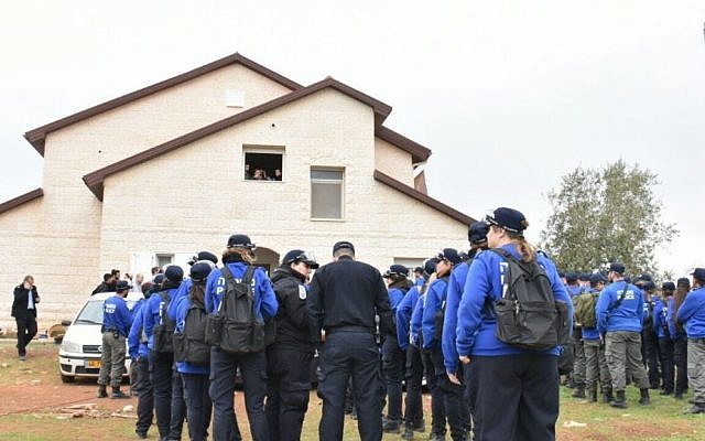 Police officers being clearing out protesters and residents of nine buildings found to have been built illegally in the Ofra settlement on February 28, 2017. (Israel Police)