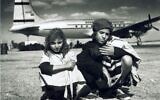 Illustrative: Children being airlifted from Yemen in Operation Magic Carpet, in front of an Alaskan Airlines plane. (Courtesy AJM)